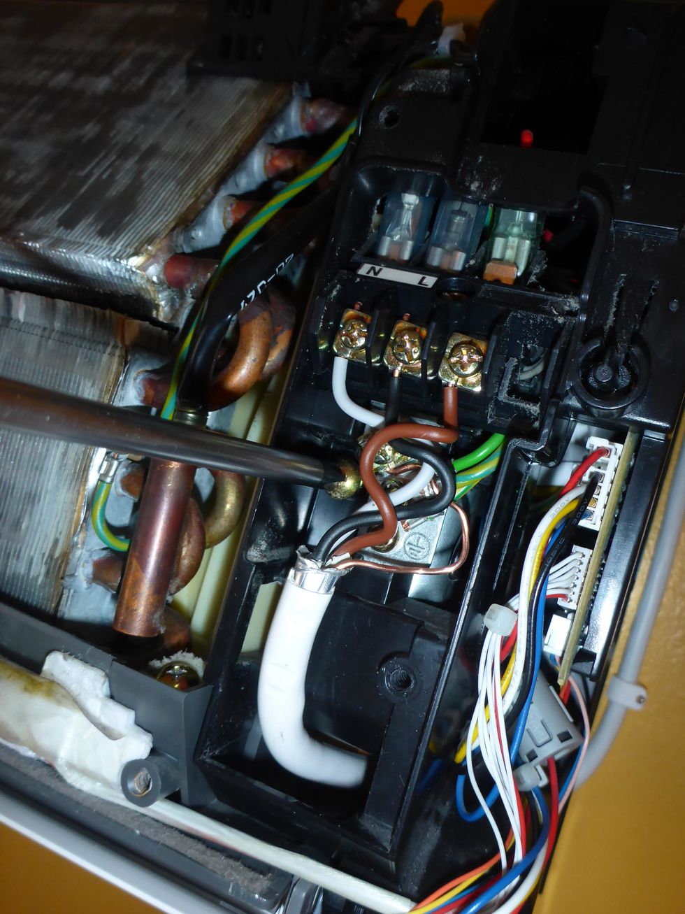 Remove the Circuit board unit screw. Notice that this screw also locks the fan motor bracket below.