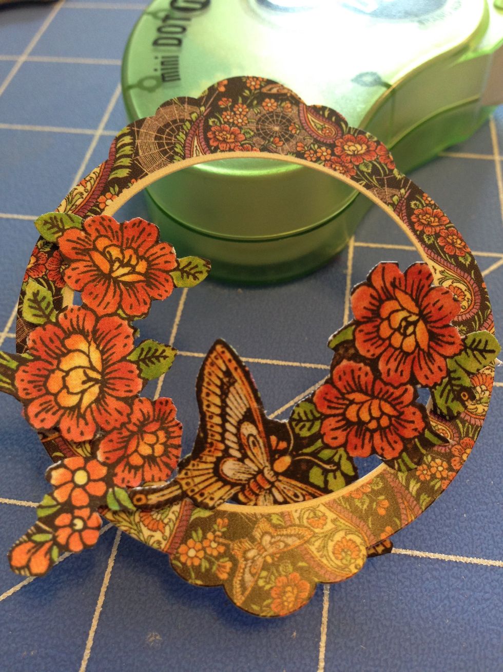 Remove the decorative circle from the sticker sheet. Place the fussy cuts inside to plan your focal image. Cut as much or as little as you need to fill the opening.