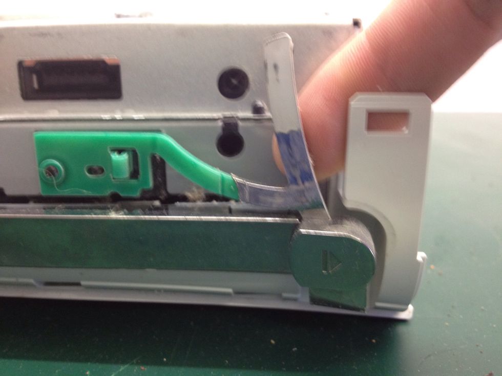 Remove the eject button, pulling it away from the right hand side. It may be quite stiff, but don't worry.