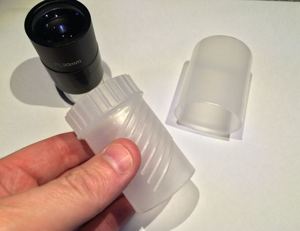 Remove the eyepiece from its case and use the smaller part of the case
