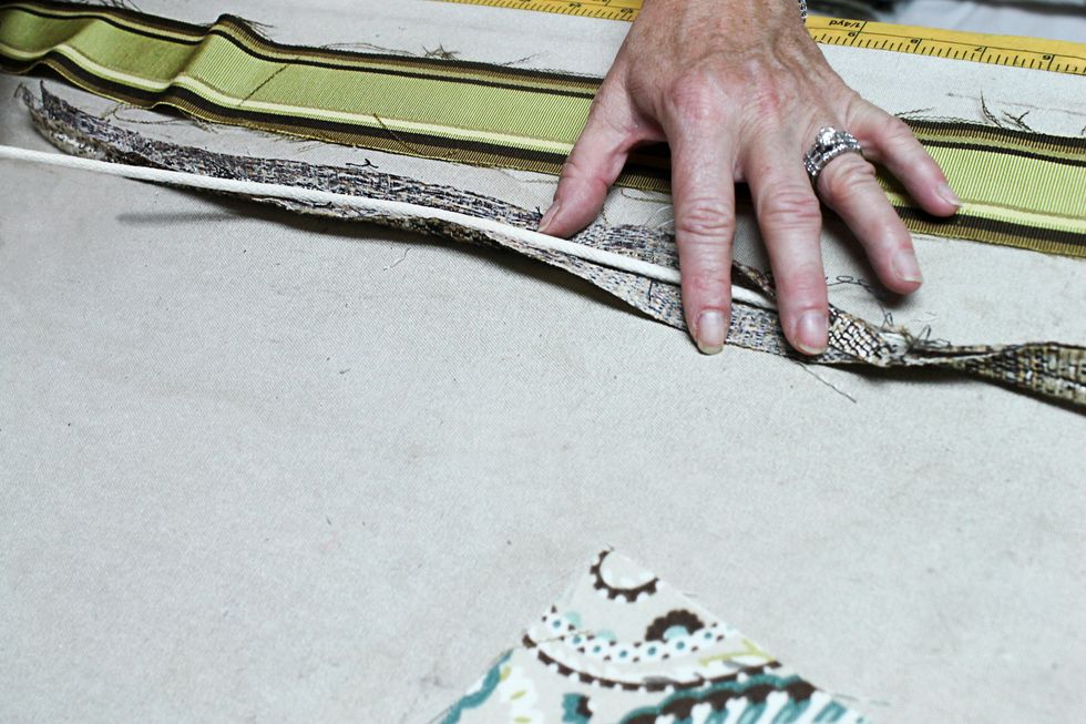 Remove the fabric covering the piping if you are using the existing piping.  Set aside.