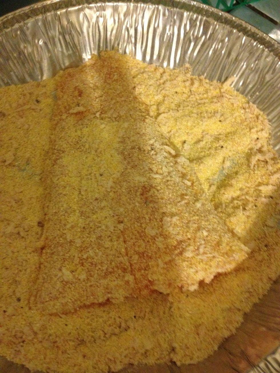 Remove the fish fillets from the buttermilk and tap to remove excess. Then dip the fish into the corn meal mixture (on both sides of course). Pat it on so your fish has a nice coating.