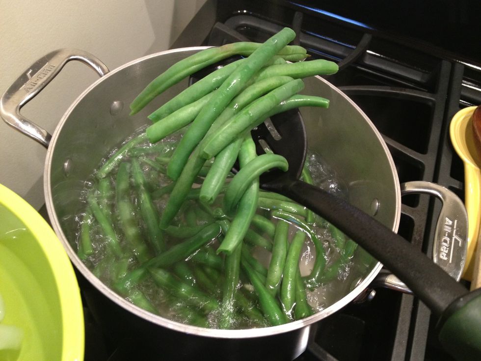 Remove the green beans with a slotted spoon.