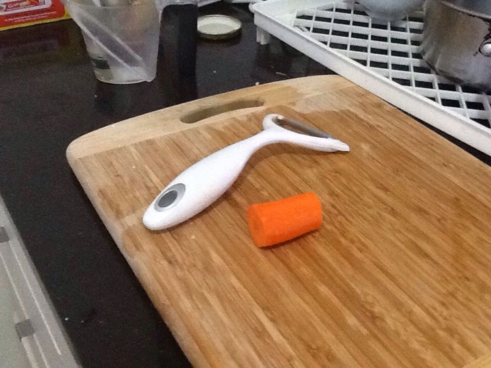 Remove the head of the carrot and peel it.