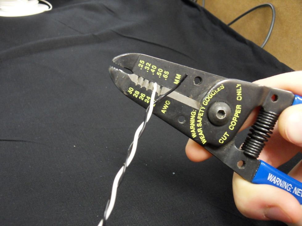 Remove the insulation from both wires using the 24 AWG size hole.