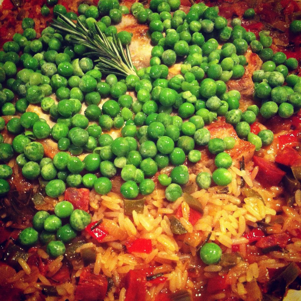 Remove the lid (its less messy) and Add the peas and a sprig of rosemary to the top.