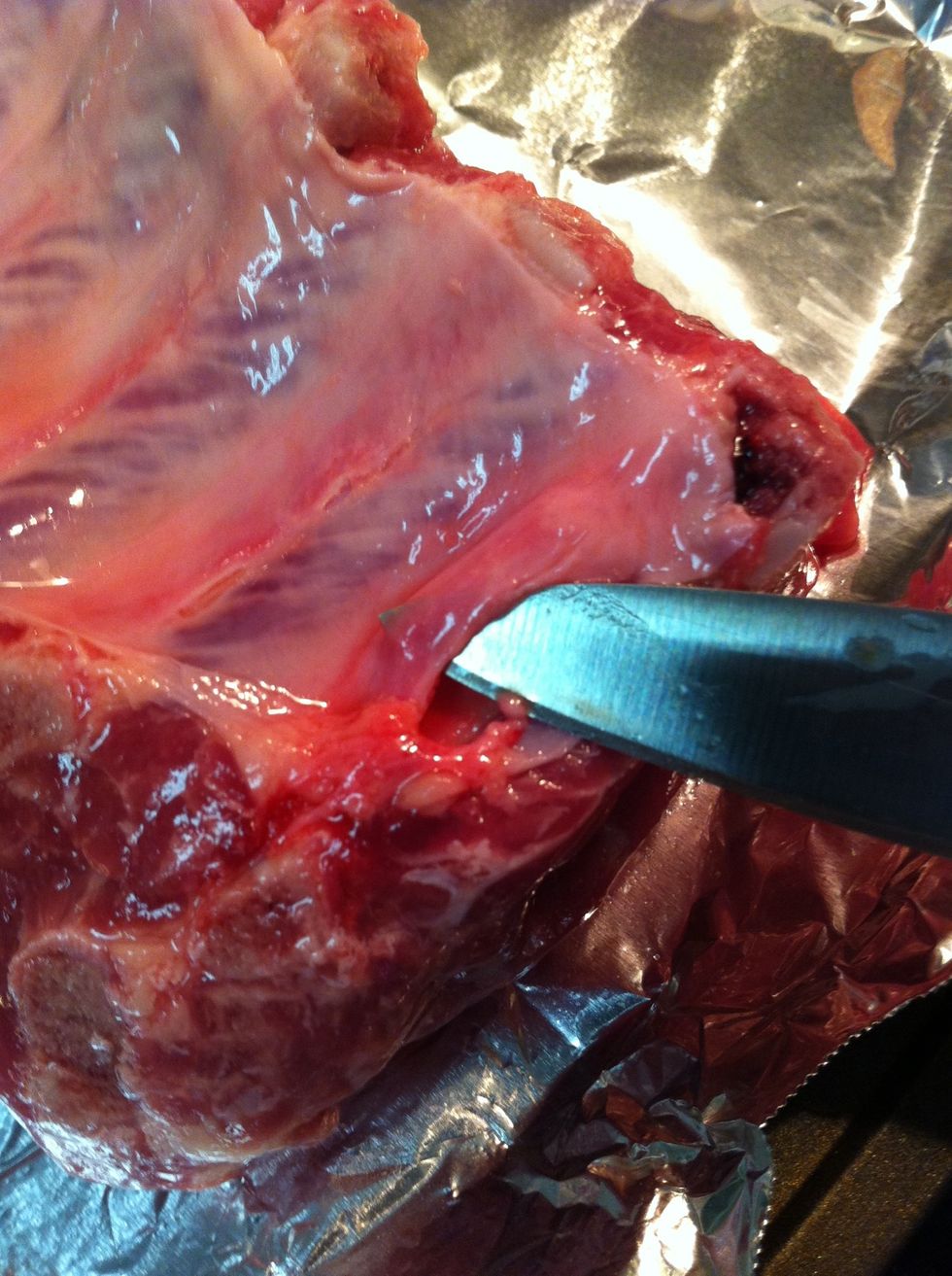 Remove the membrane (optional but ribs will be less tender). Start by slicing it, use a paper towel to pull it off. It's too slippery to just use your fingers.