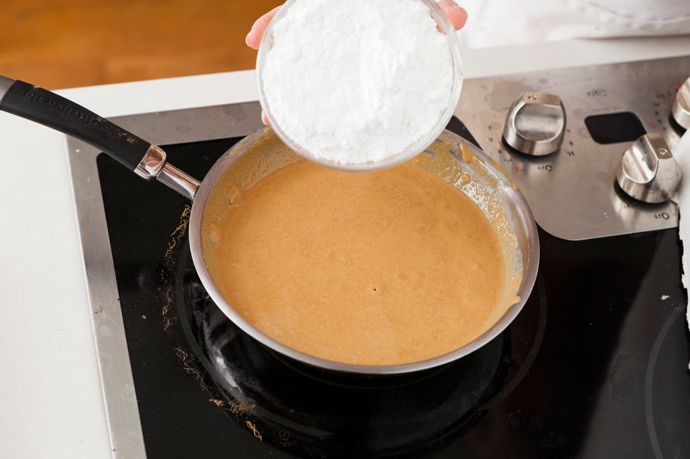 Remove the mixture from heat and add the powdered sugar. Add \u00bc cup at a time, making sure to stir constantly to dissolve the powdered sugar into the mixture. Set pb mixture aside to cool.