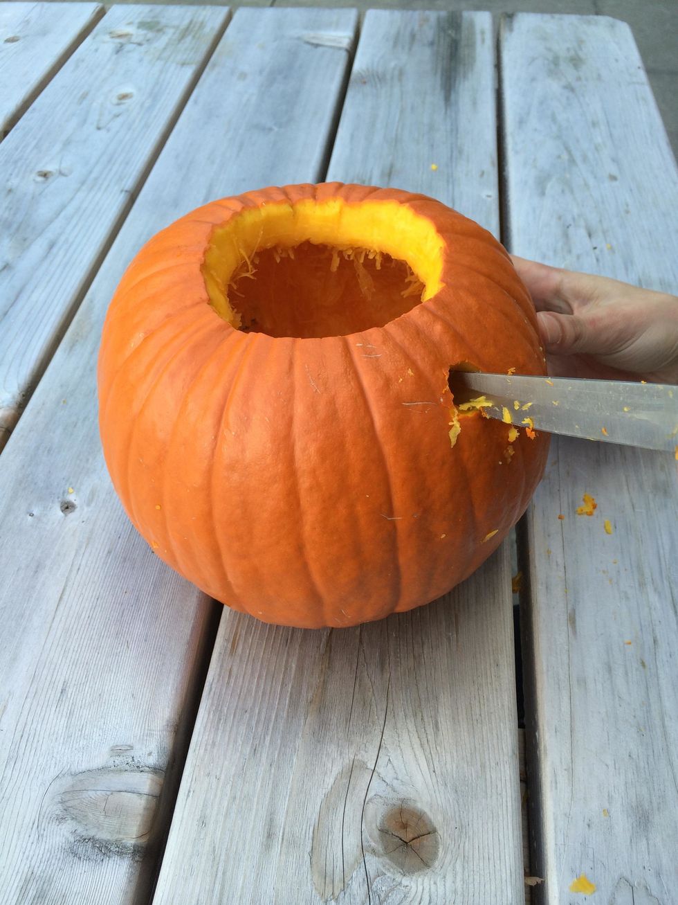 Remove the olive oil dispenser. Then, using the resulting hole as a guide, slowly carve out a larger hole to fit the olive oil dispenser in it's entirety.