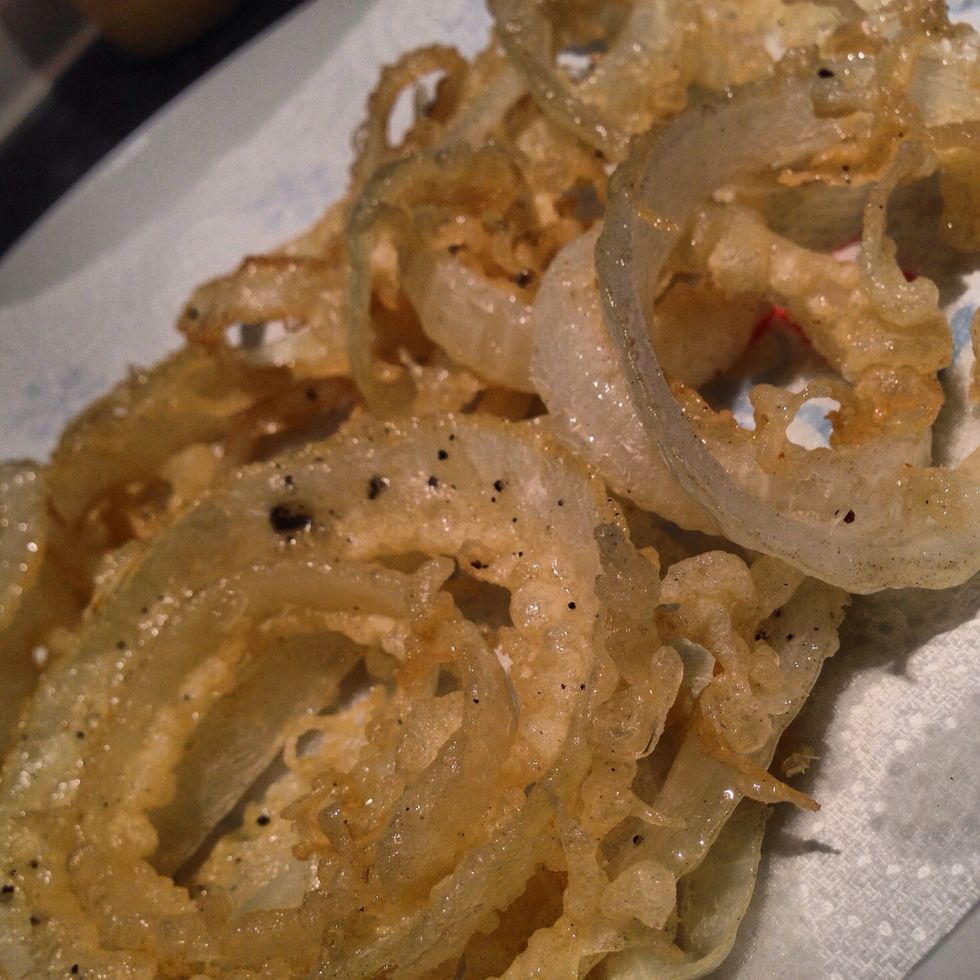 Remove the onion rings from the oil and place on a piece of tissue paper to let dry.