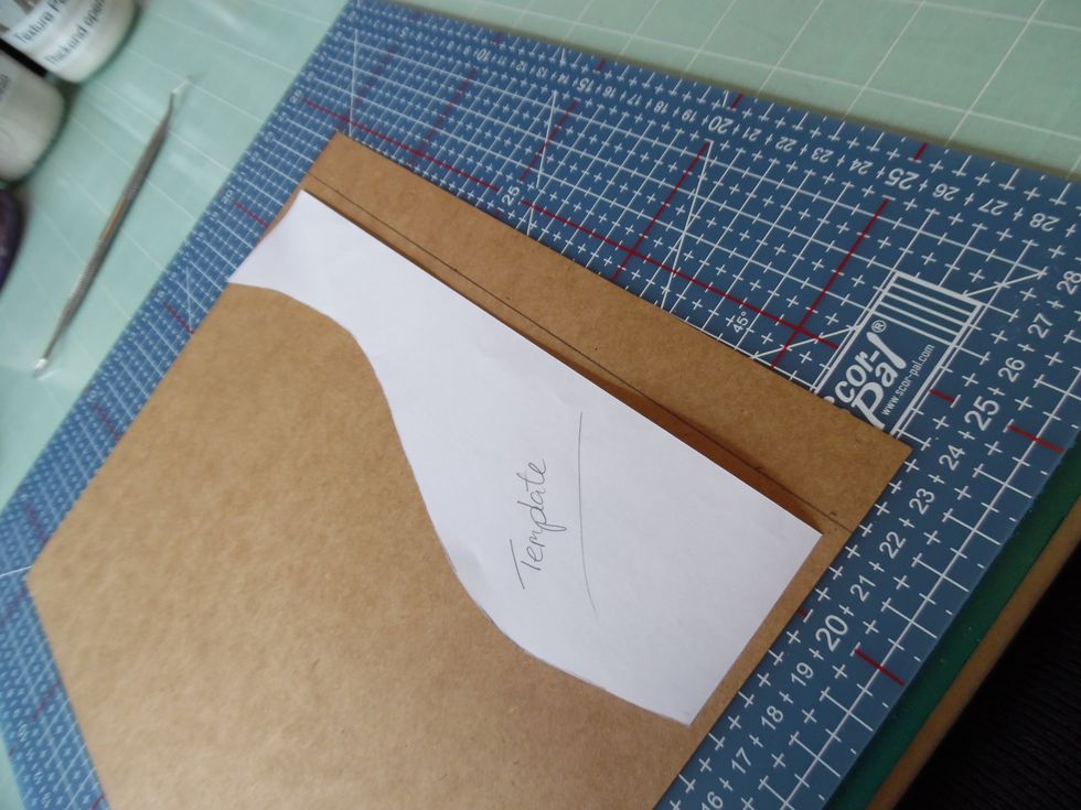 Remove the paper and you get a template to transfer the required shape. Place on the card and offset the straight edge of the template by the height that you want the lip to protrude from the base.