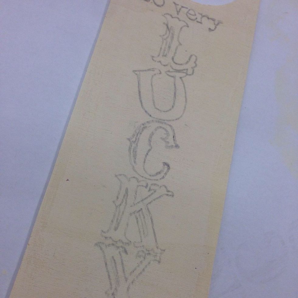 Remove the paper and you will see your letters in outline. We traced the highlighted portions, but quickly realized it was easier to add them in after filling the letters in with black paint.