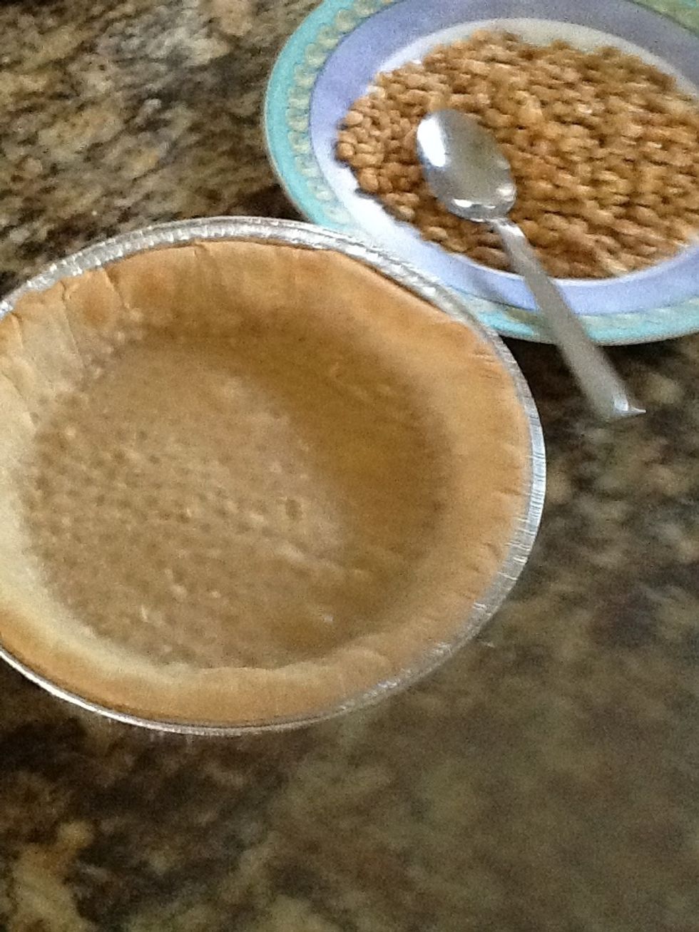 Remove the pie crust from oven. Remove the beans from the pie as well. ( before you finish the 2nd bottle of wine, make sure you do this step!).