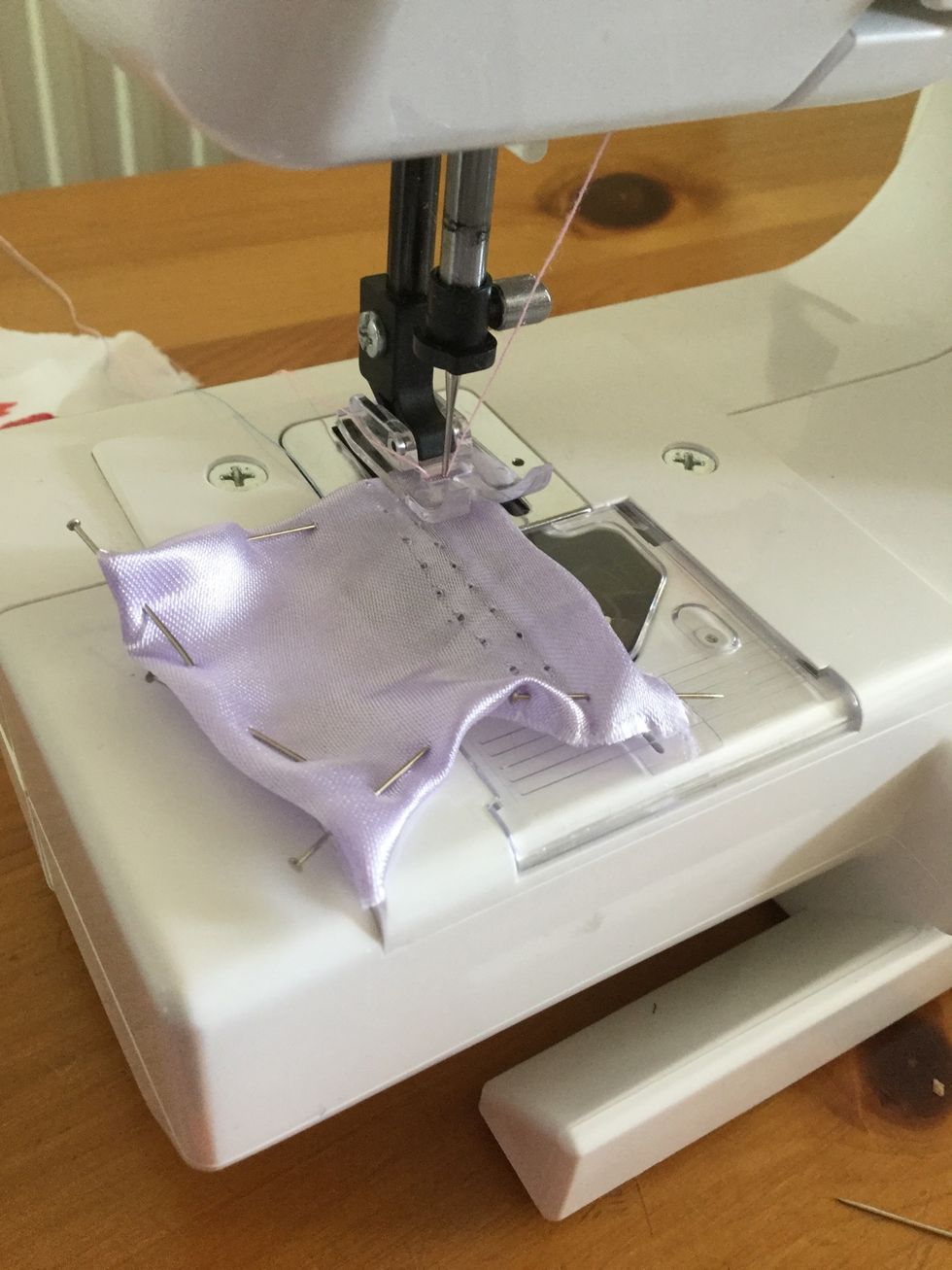 Remove the pins from one edge of the square and sew along that edge. When you get to the next edge take out the pins and sew, and so on and so on. Repeat this for every square.