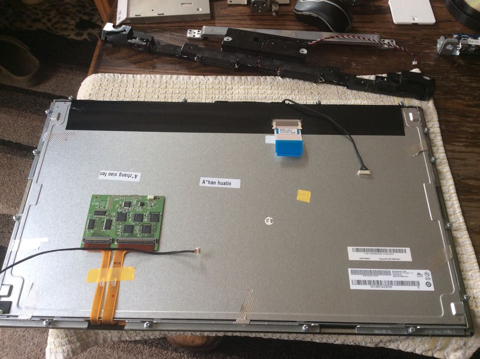 Remove the plastic bezel. Very carefully remove the lower metal angles stuck to the LCD and screen. I used a small flathead screwdriver, slowly easing off the metal. They did bend a little.