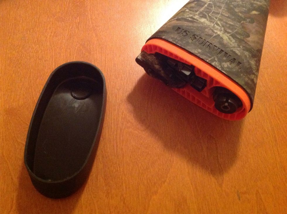 Remove the plastic cap on the rear of the stock (the butt end of the gun). Careful! It might come off hard if it is new!