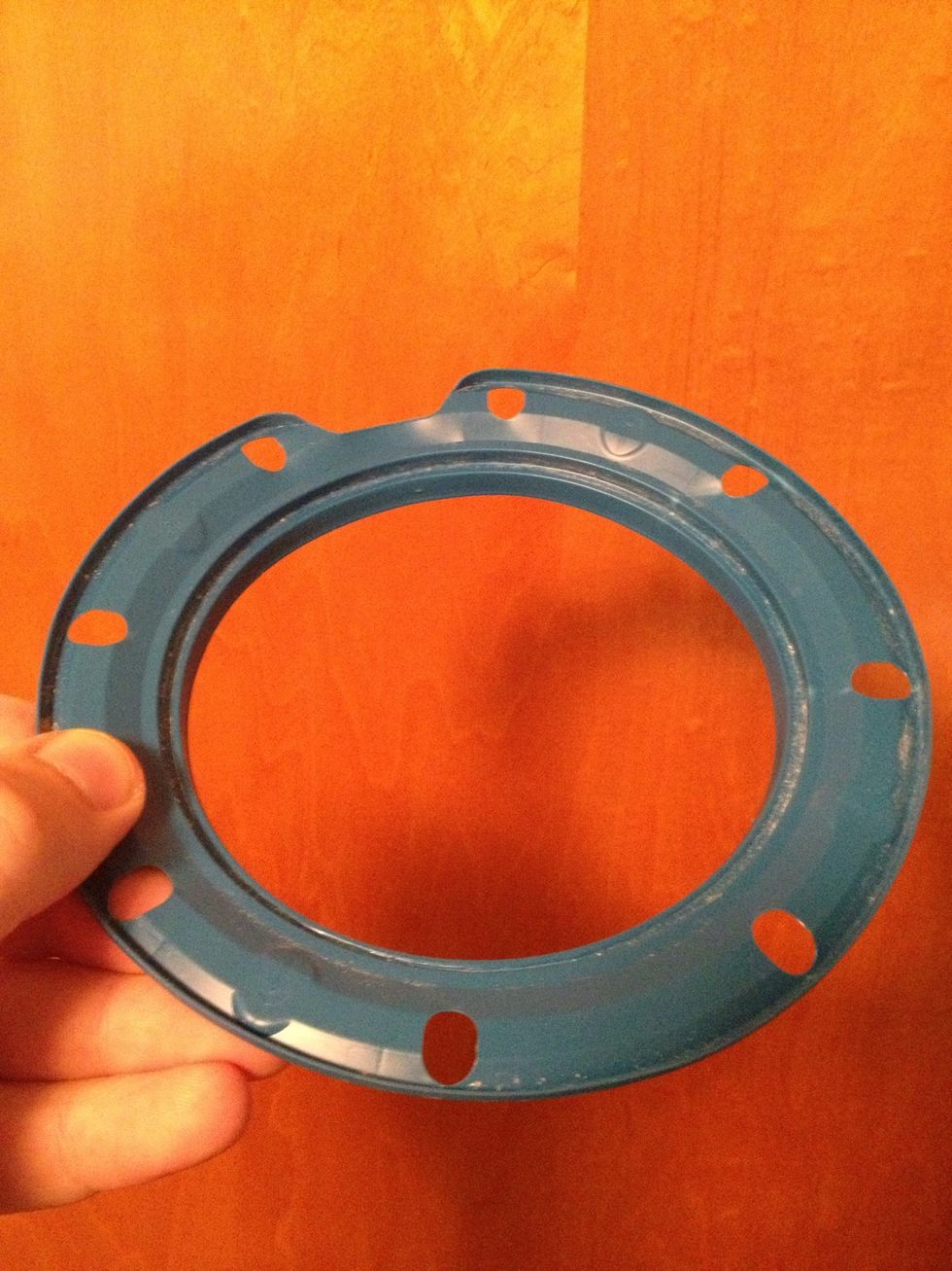 Remove the plastic ring with holes. You have to pry a bit but it snaps right off, no tools required!