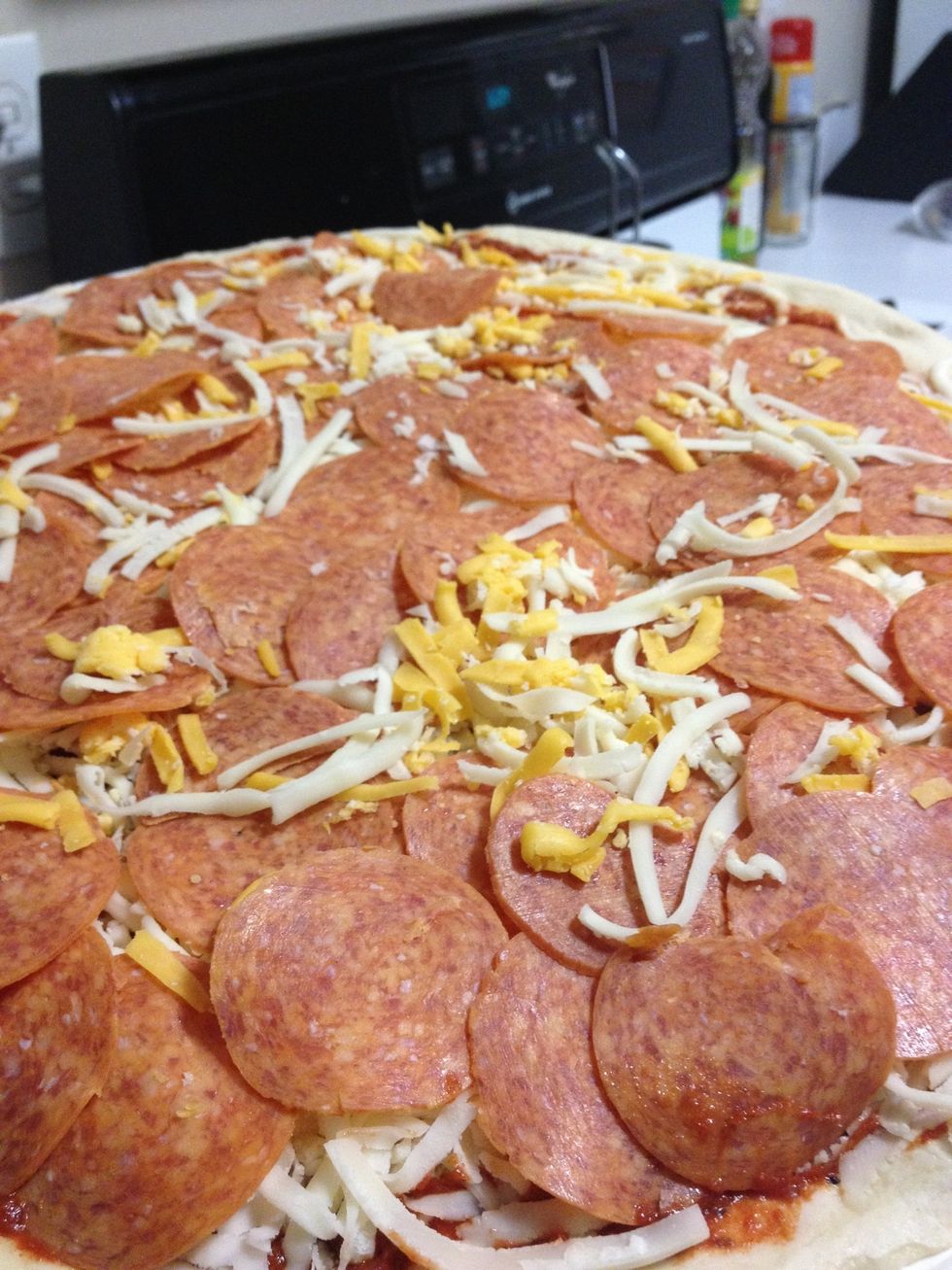 Remove the plastic wrap from the pizza. Put pizza/paper tray on aluminum grilling tray or heated pizza stone. Place in the center of the grill surface and close lid.