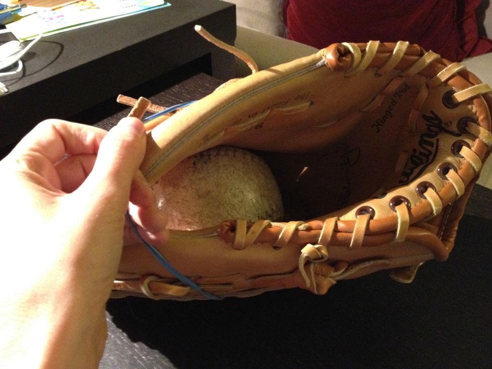 Remove the rubber band and ball.