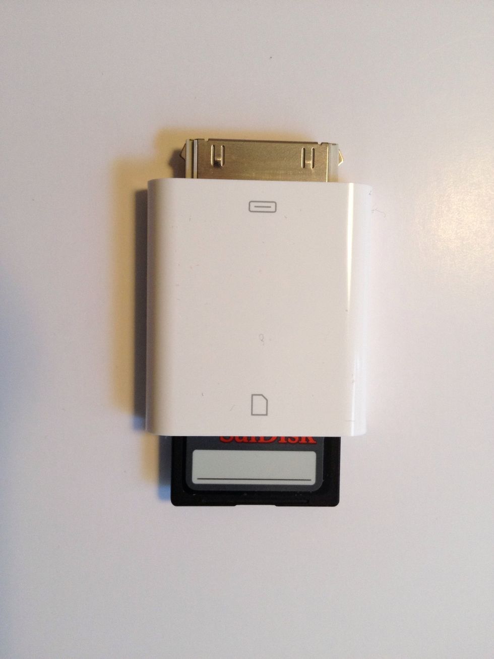 Remove the SD card from the SD Card Reader and insert the card into the iPad Connector.