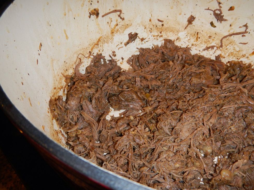 Remove the shredded meat from the pot. Pour the au jus in, we're going to make a tasty sauce!