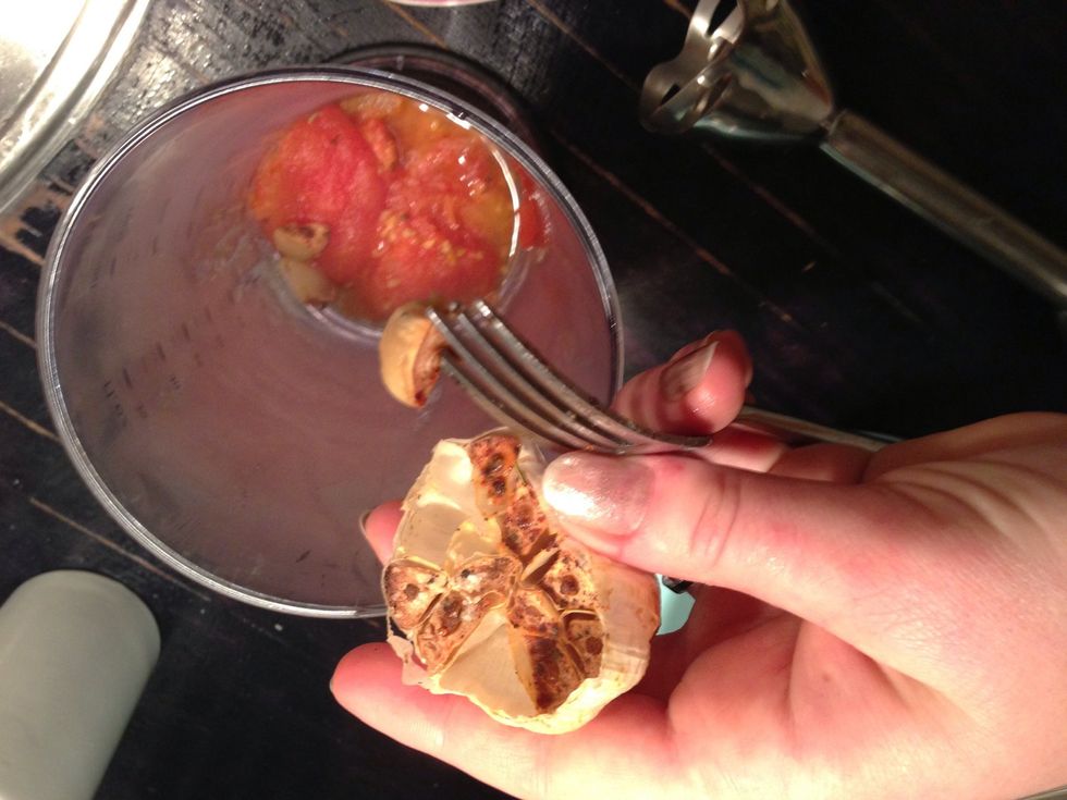 Remove the skin from the tomatoes and put them in a blender. And take out the garlic and add as well.