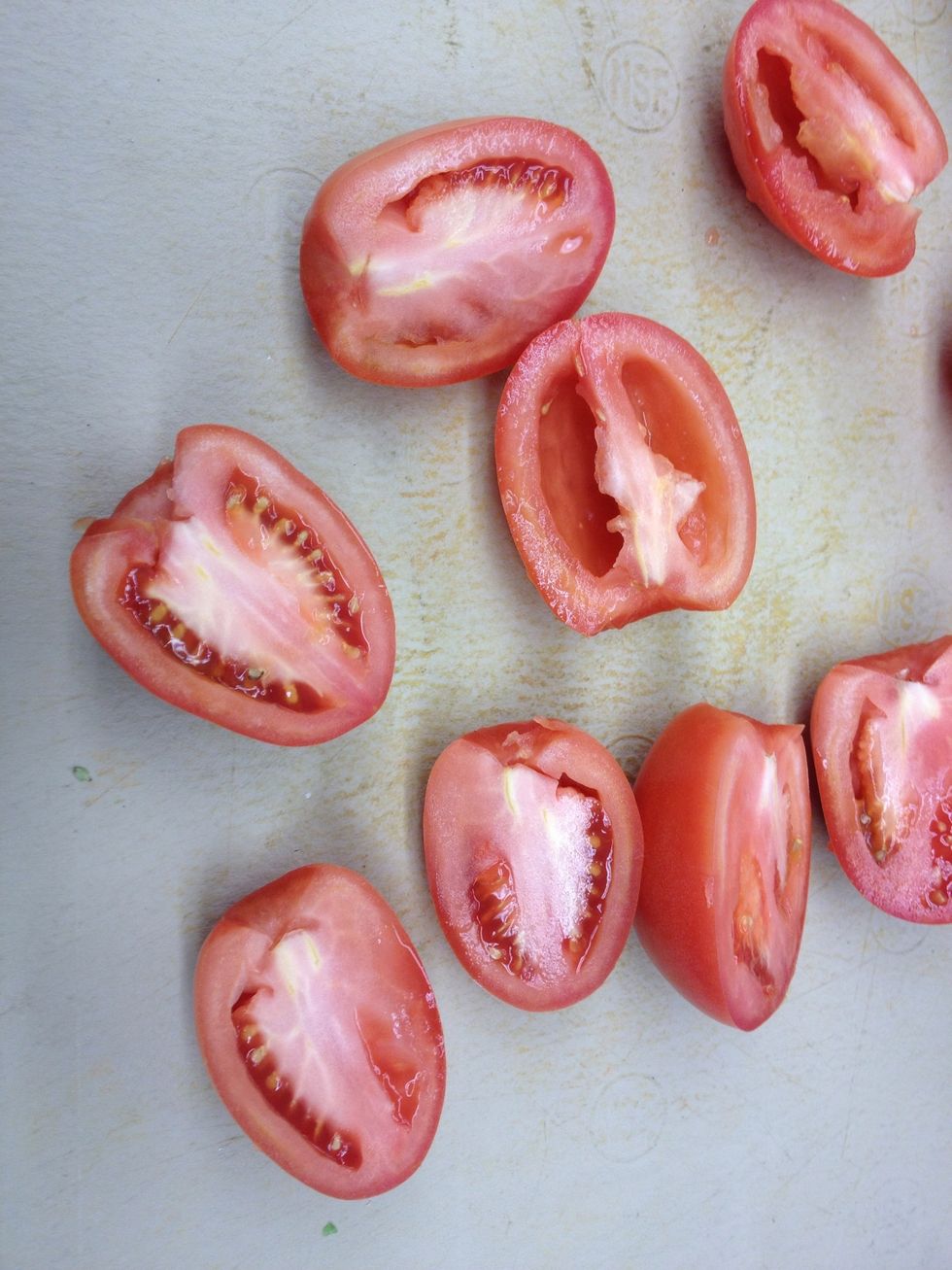 Remove the stem, cut in half, and deseed the tomatoes with your finger or a small spoon