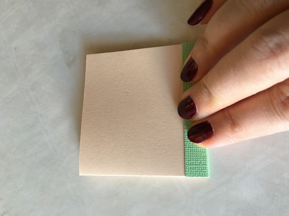 Remove the tape-backing from the second flap and attach it to the other side of your booklet.