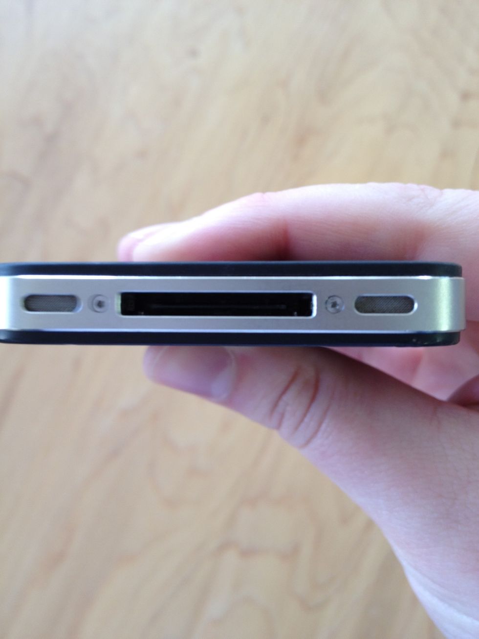 Remove the two dock connector screws located in the bottom with either a #00 or 5-point screwdriver. CDMA iPhone 4's and 4S' will have security screws