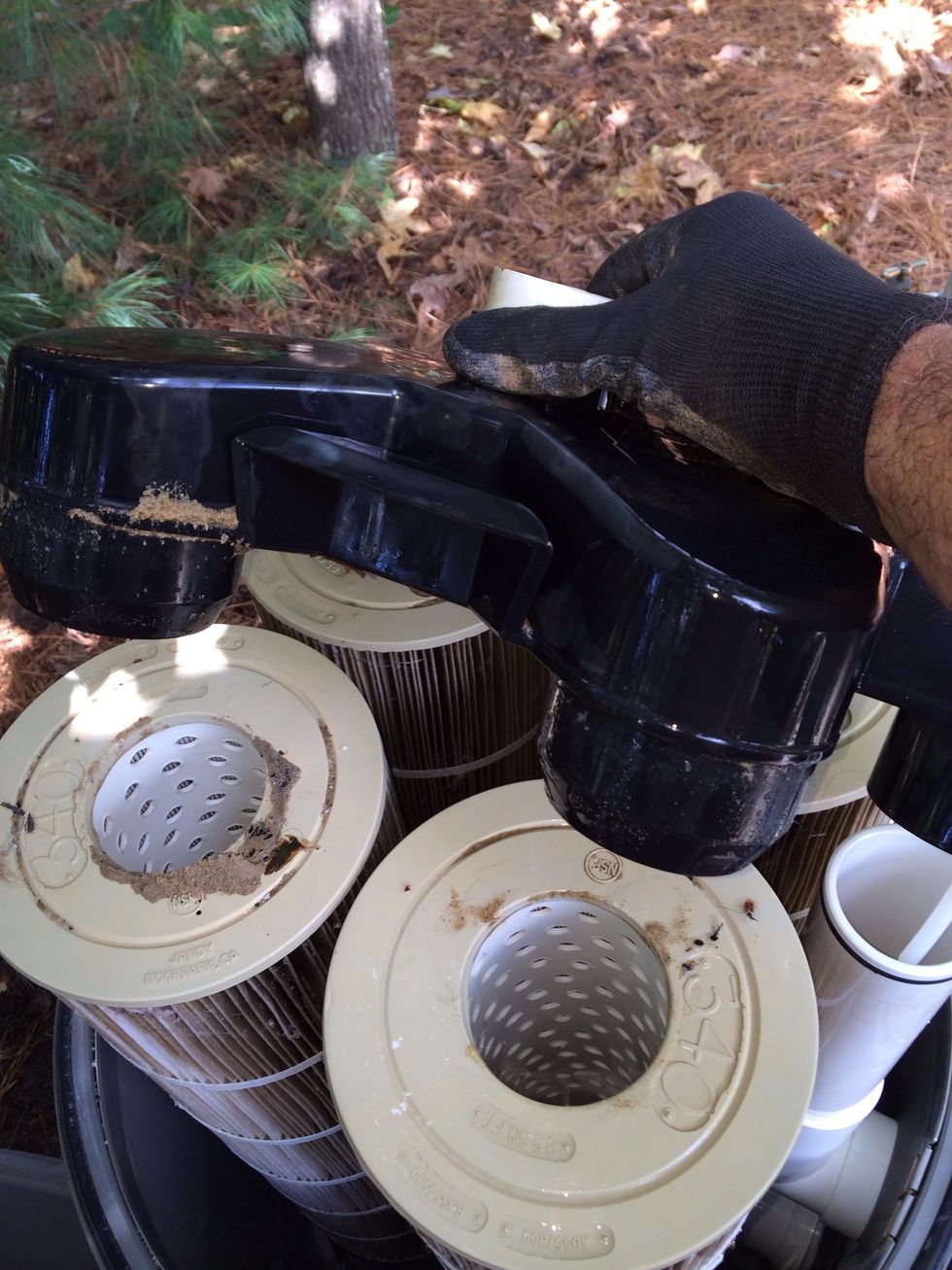 Remove the water distributor cap, hose it down. clean the little steel filter on the top and put it to the side
