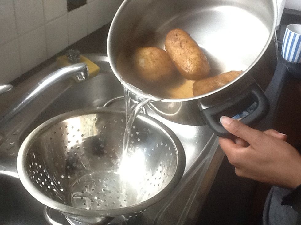 Remove the water from pot with the potatoes.