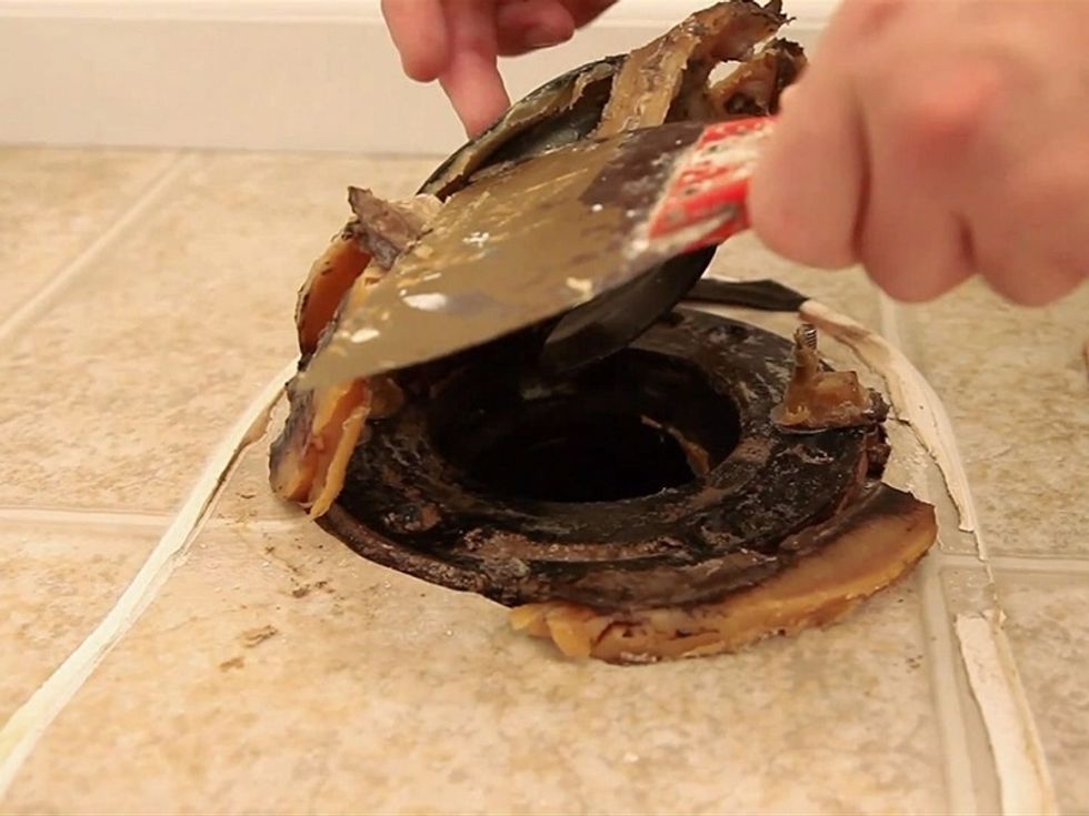 Remove the wax ring with a putty knife. Place a rag or towel in the opening to prevent any old wax from falling in and to eliminate odor. Scrape up any remaining caulk with the putty knife.