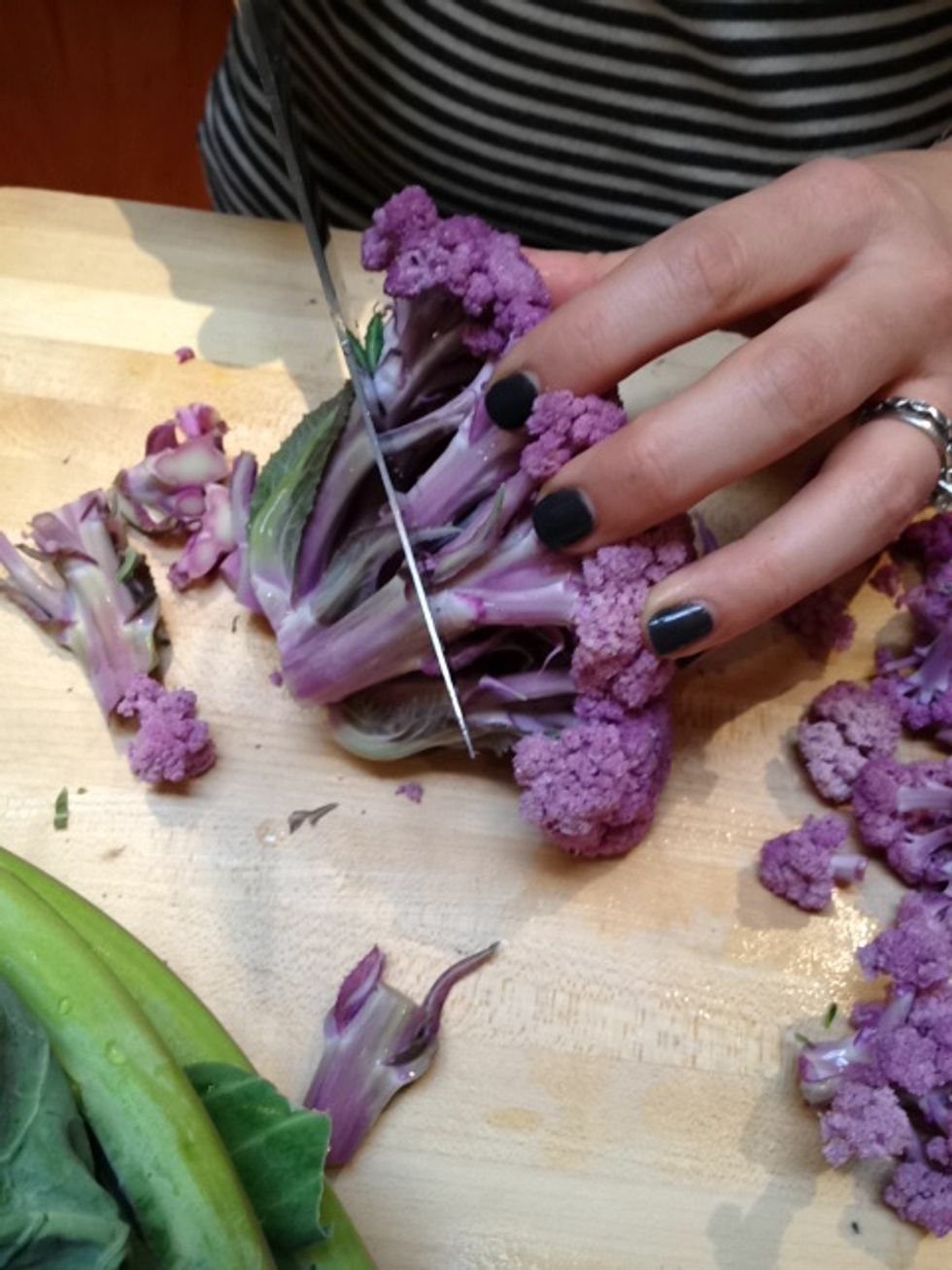 Remove the woody stem, thus separating the head of cauliflower into florets.