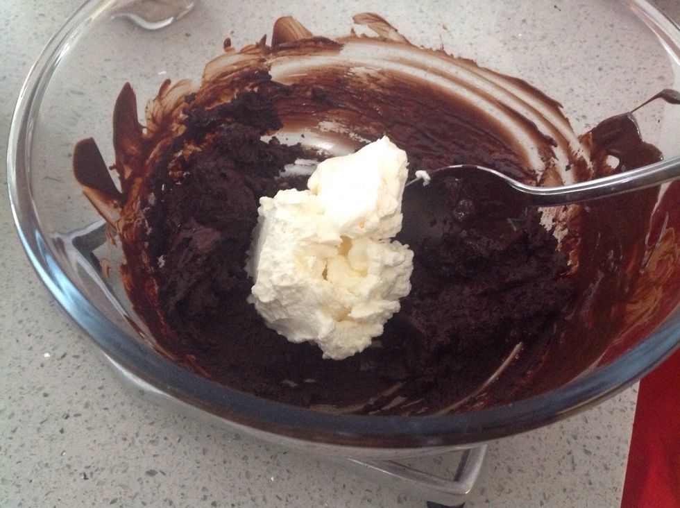 Remove thickened cream from the refrigerator and add half to the dark chocolate, stirring lightly until well combined.