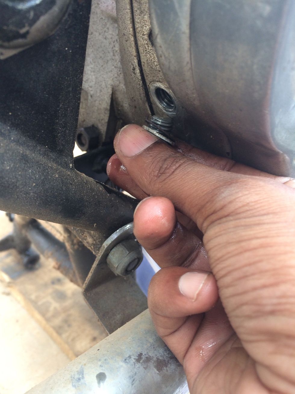 Remove this bolt that covers the level indicating hole. You should add transmission fluid until it starts spilling from this hole.