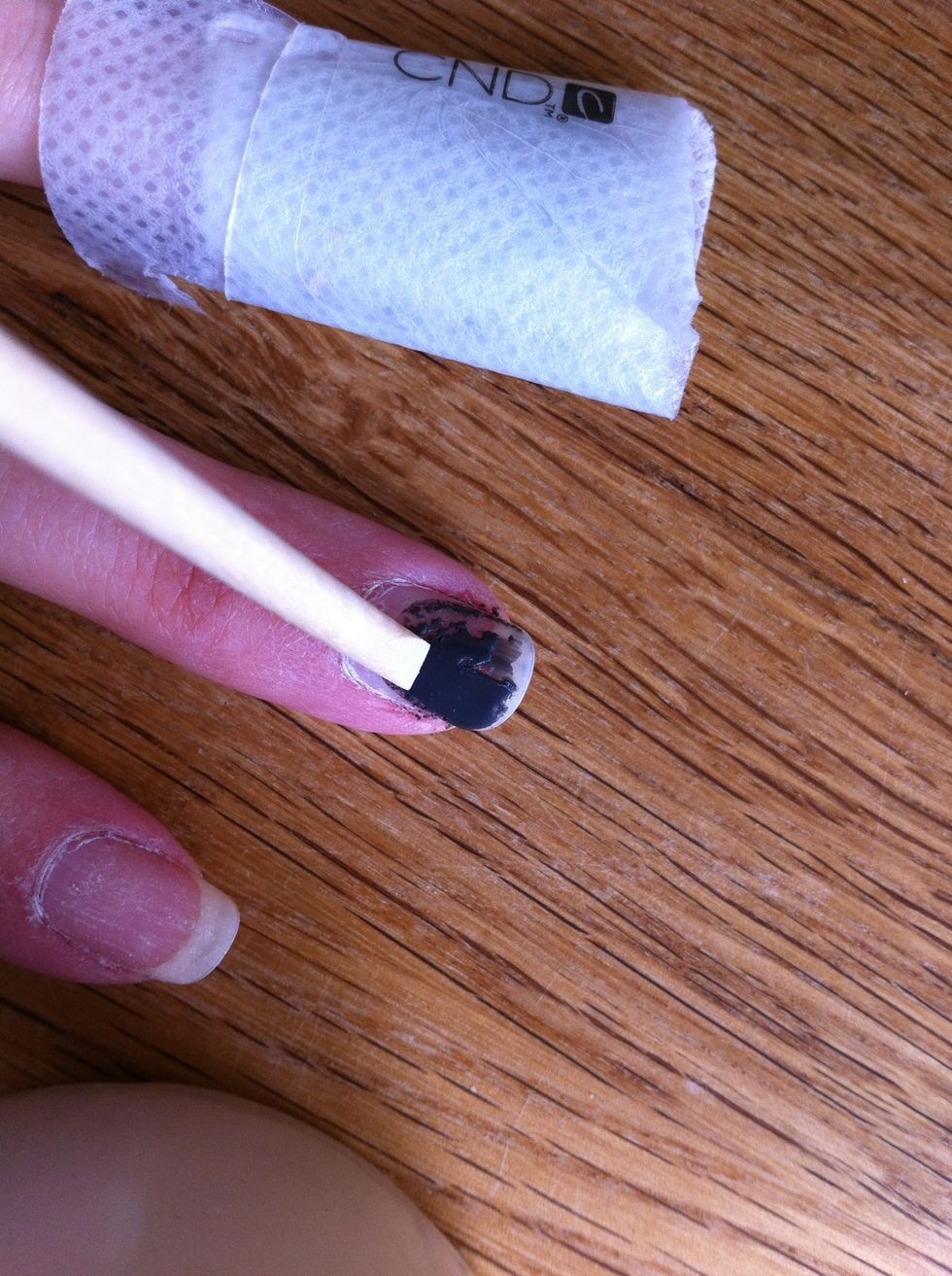 Remove using a twisting motion. Any remaining polish can be scraped off with the orange stick. You probably want to avoid inhaling what comes off of your nails.