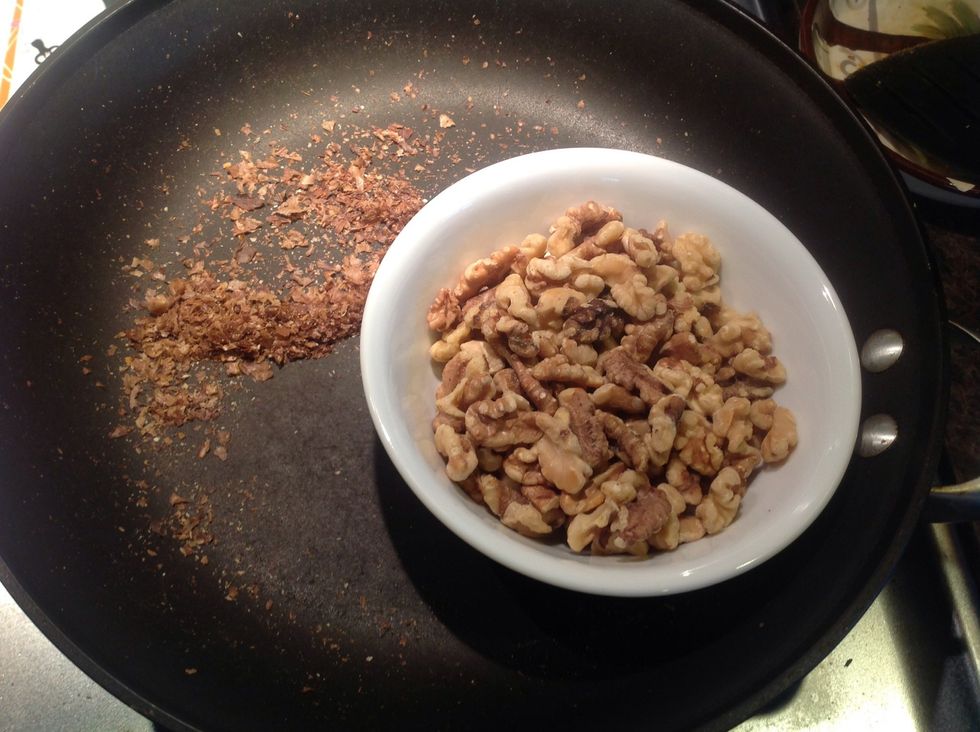 Remove walnuts from pan in small handfuls, rubbing them together to loosen as much of the bitter skin as you can.