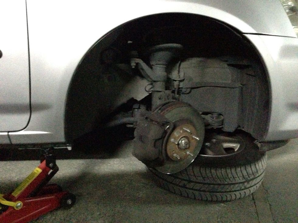 Remove wheel and place it under the front suspension. Just in case... CAREFULLY turn steering so the caliper faces out.
