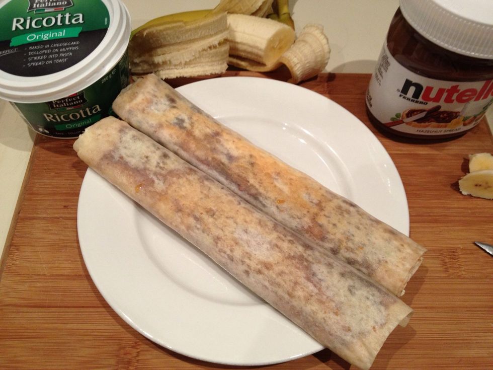 Remove wraps from pan and allow to cool briefly - just enough so you can hold onto them as you cut in half without burning your fingers.