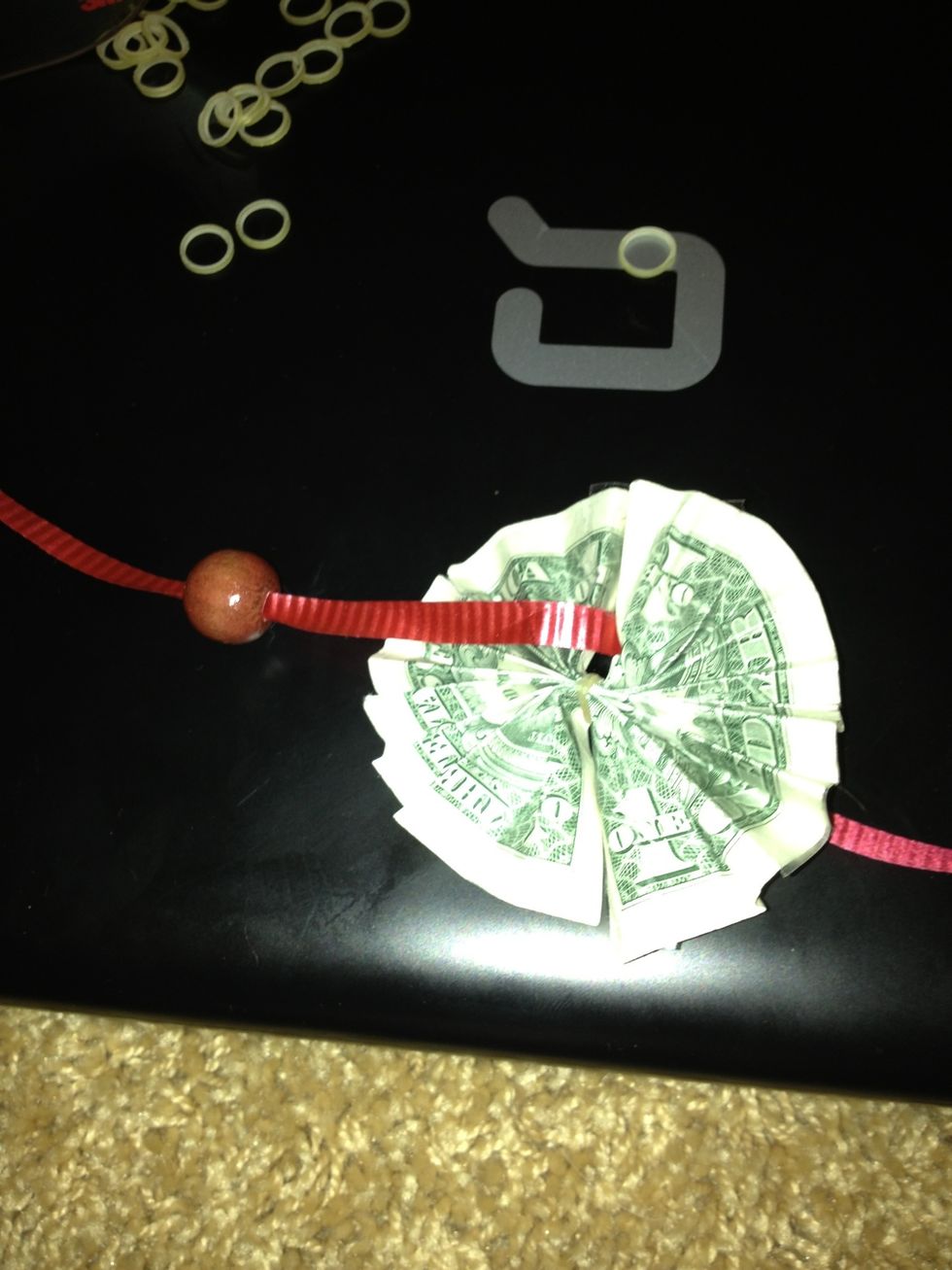 Repeat and continue to add on, be creative and add as many beads or dollars. Till your satisfied before you tie the end ,and that's the basics on how you make a money lei :)