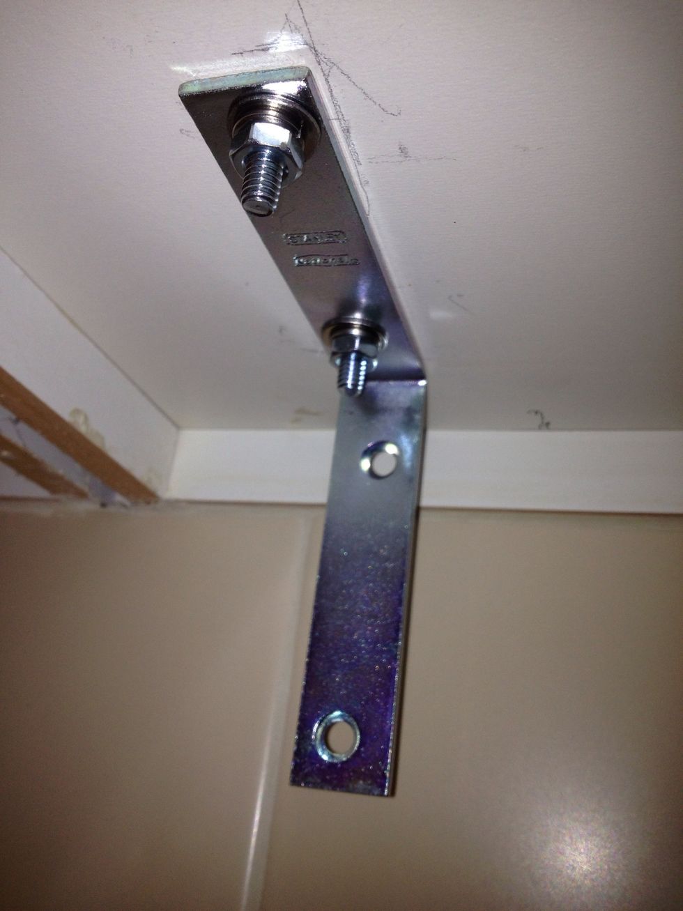 Repeat for the other bolt and tighten the nuts while holding the bolt head with a screwdriver (depending on the type of bolt).