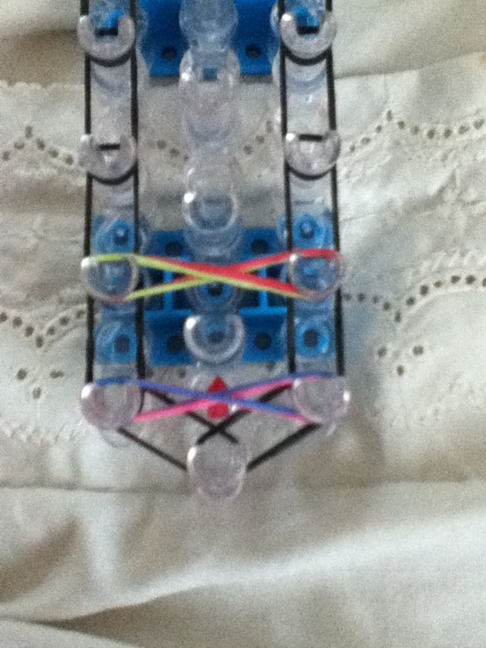 Repeat step 10 (Twist the bands into a figure 8 and place it onto the loom like this)