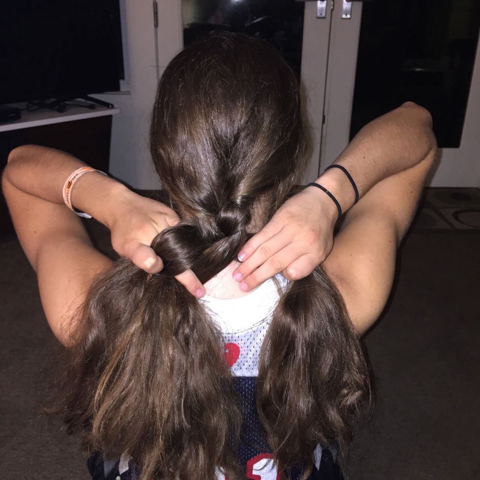 Repeat steps 5-6 until you get to the end of the hair. Make sure to leave about 2-3 inches of loose hair at the end of the braid so you can fasten the ponytail holder to hold the braid in place.