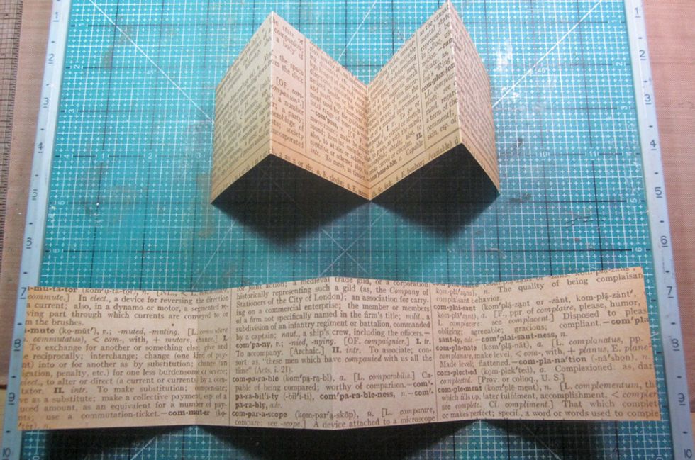 Repeat steps one and two with another piece of paper and then fold them both to have peaks and valleys as shown above.