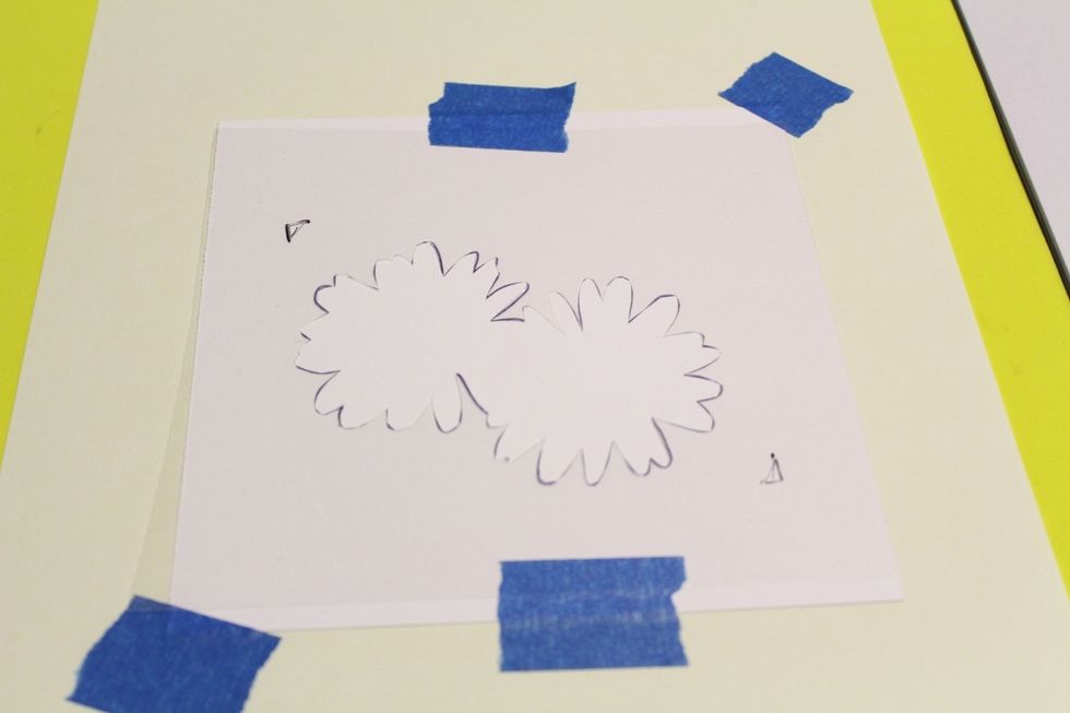 REPEAT THE FOLLOWING STEPS 3 MORE TIMES: use blue painters tape to adhere stencil to 6 X 6 piece of white cardstock, also securing the cardstock to a piece of scrap paper placed over foam sheet...