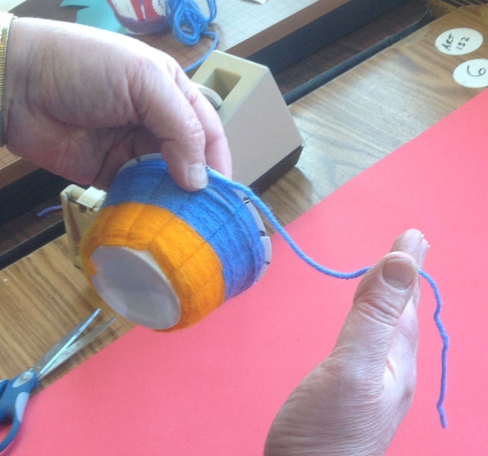 Repeat the 'in front, behind, push it down' weaving process until you reach the rim of the cup. DO NOT CUT THE YARN OFF! Leave at least 9 inches so that you can thread a darning needle onto the yarn.
