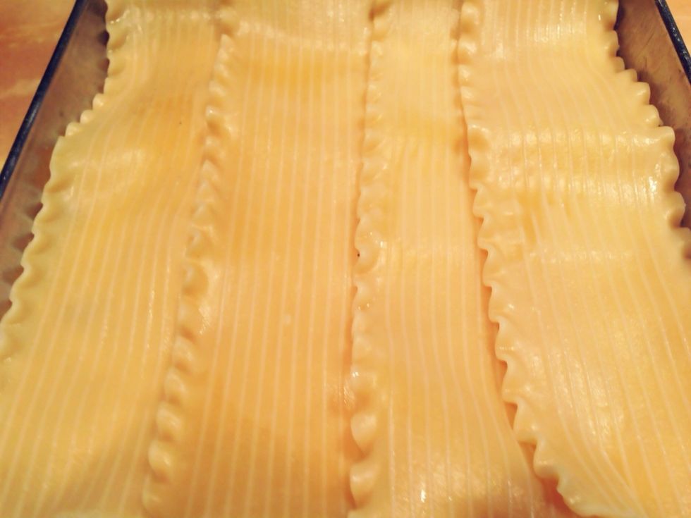 Repeat the layering, starting with the noodles. Finish with a half pound of Parmesan cheese.