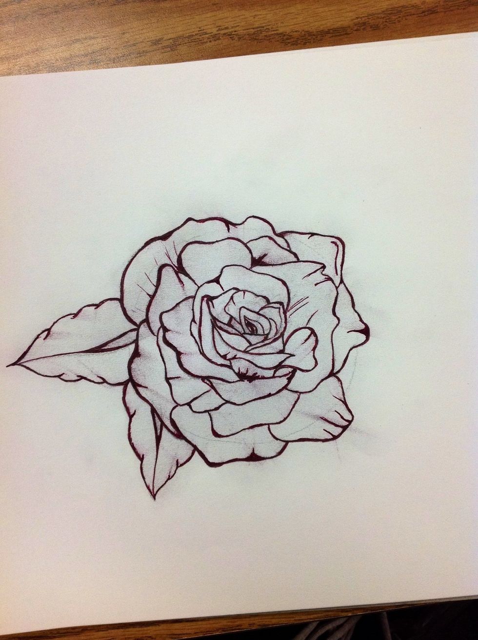 Repeat the same skill as step eight on the leaves, pulling the ink towards the middle of the leaf rather than the core of the rose. Also add lines and extra shades anywhere you please.