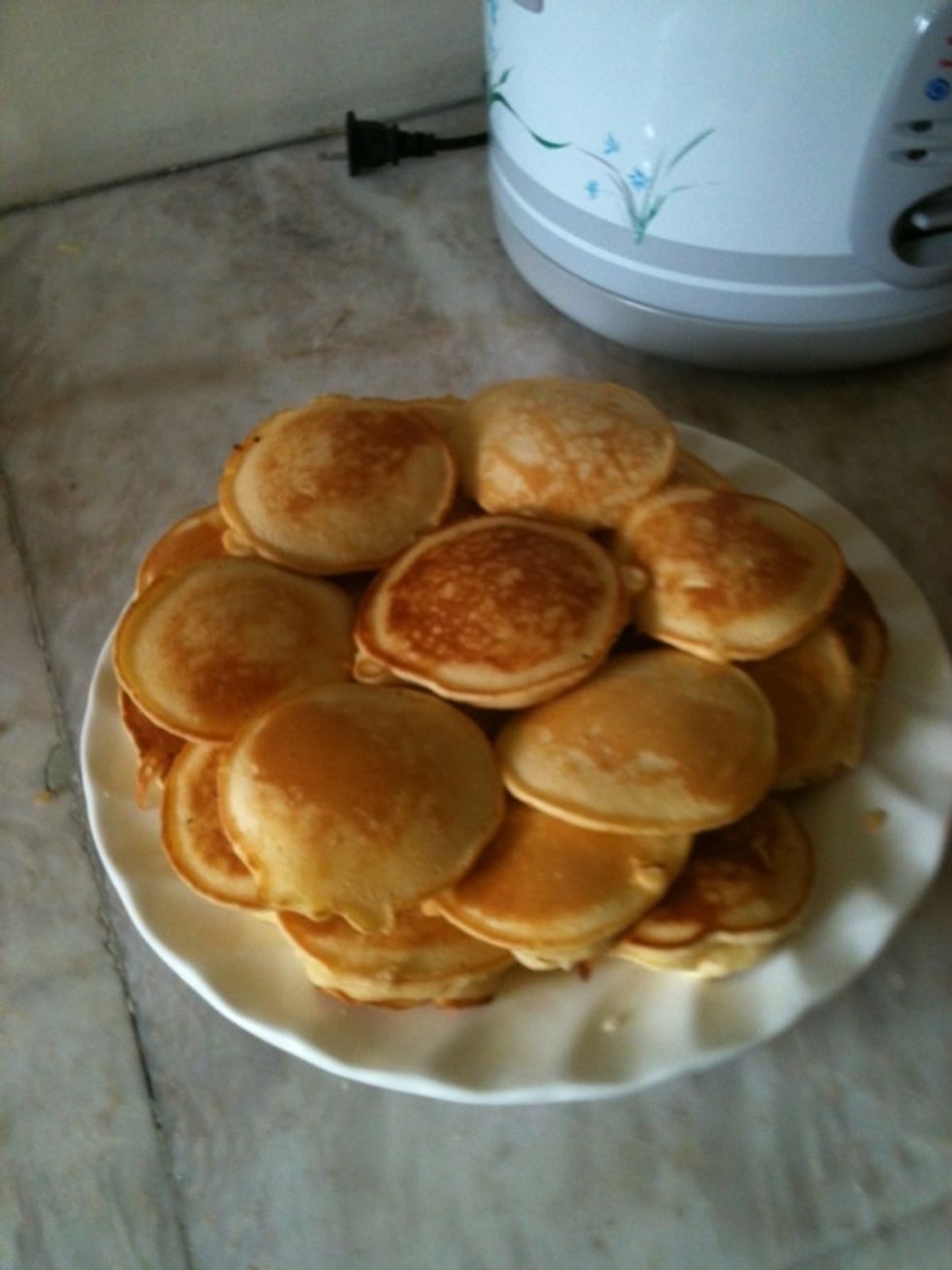 Repeat until satisfaction, or until batter is all gone. Don't forget to put butter on the pan each time before you pour the batter - it makes the pancakes taste great and look pretty. There you go :)