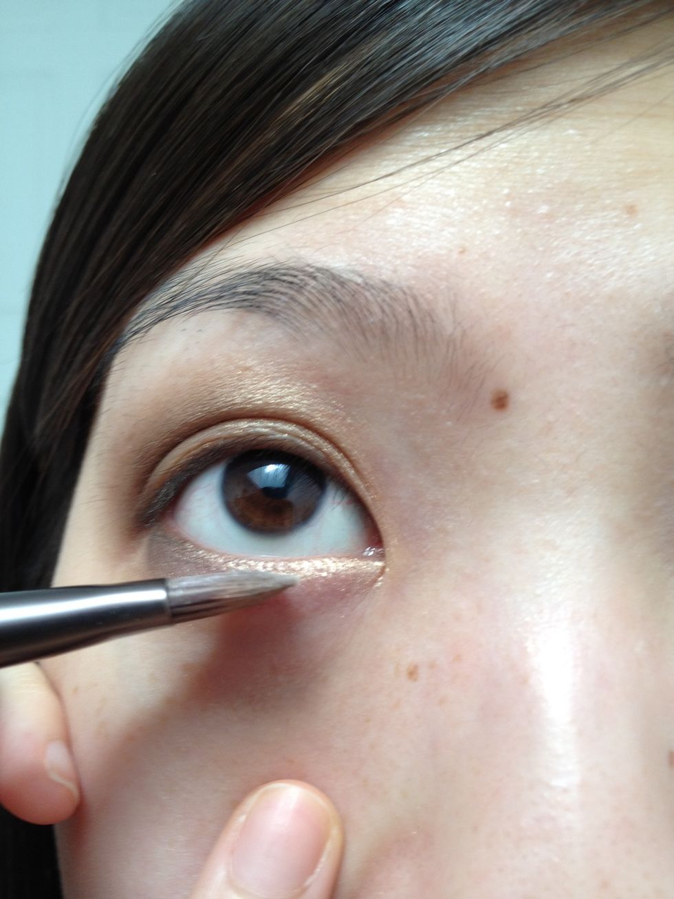Repeat with the golden bronze color in the inner half of the lower lash line. The golden bronze color hear will brighten up your eyes.